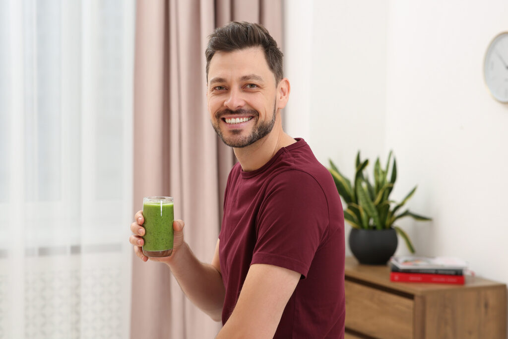 A man drinking a juice