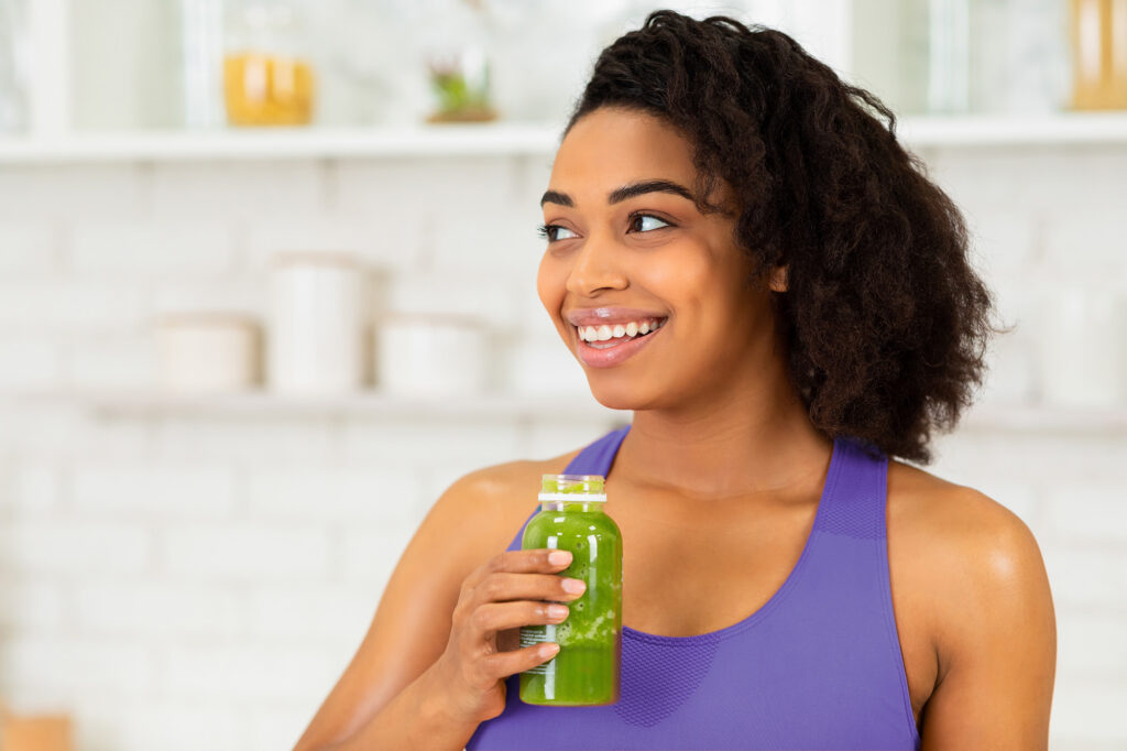 Black woman drinking juice.
