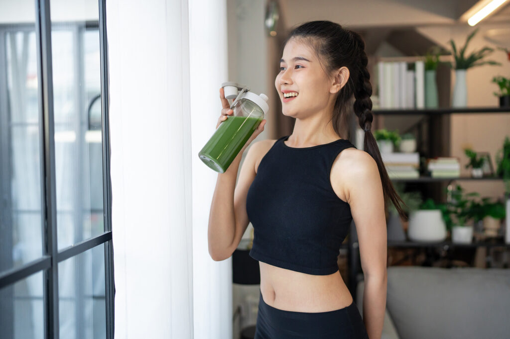 Asian woman drinking juice